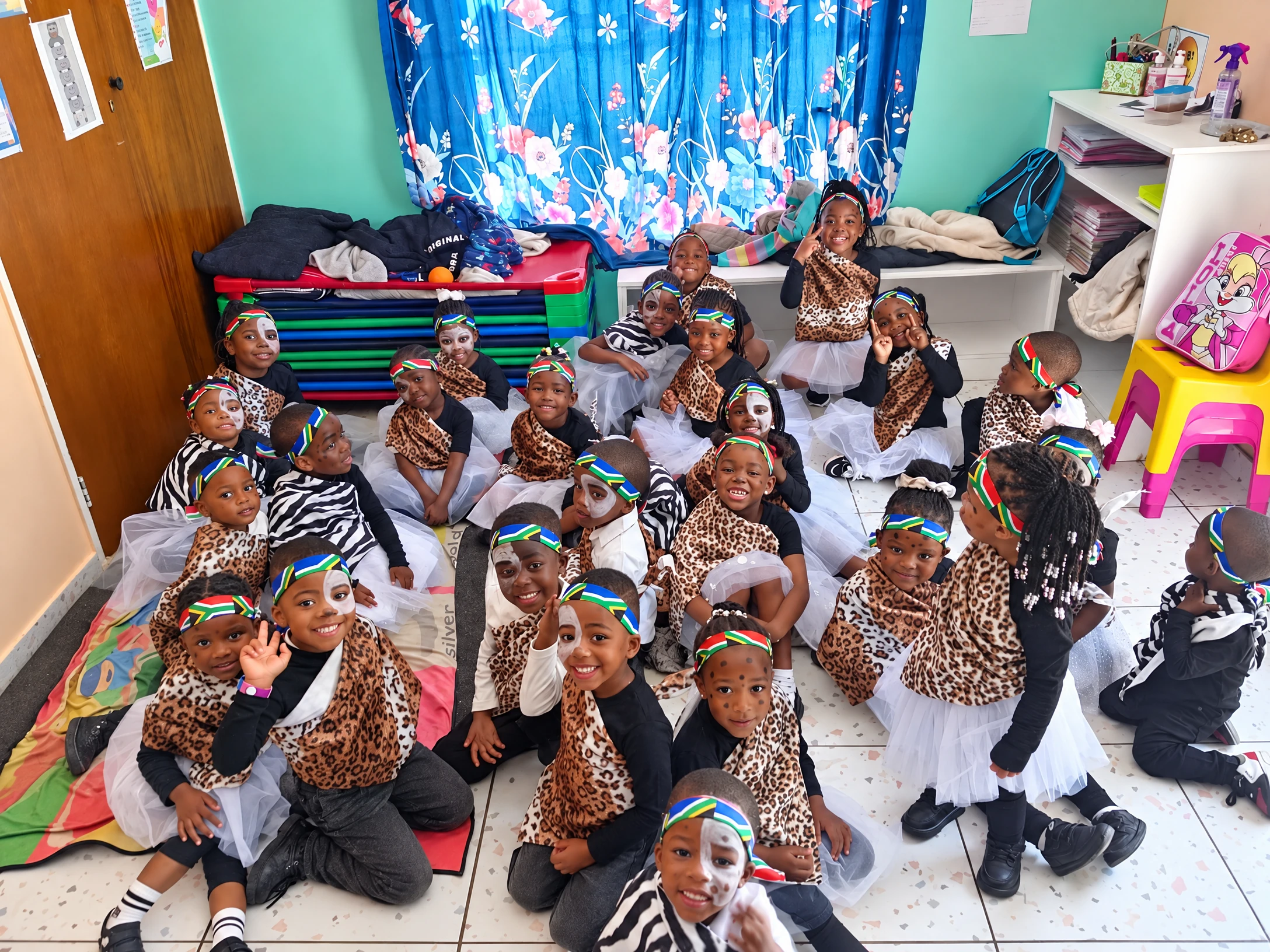 Academy children smile together in their concert outfits inside the classroom.
