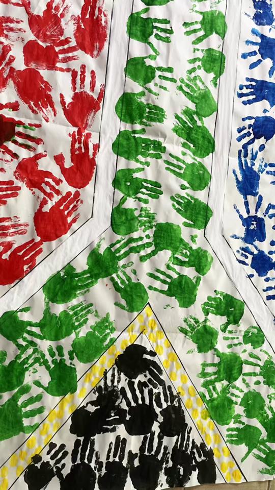 A South African flag artwork made with colourful handprints, from the academy’s TikTok clip.